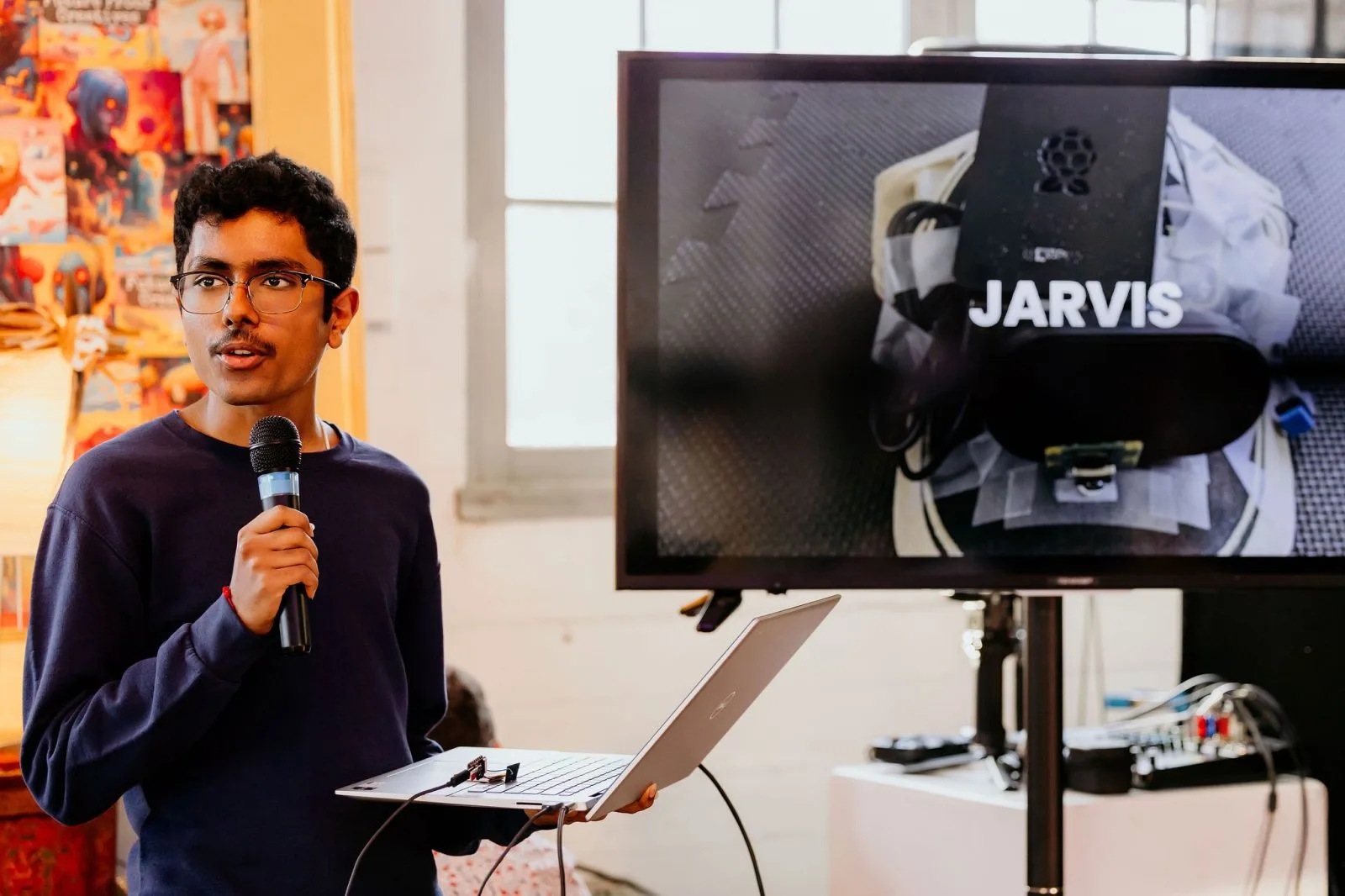 Prajwal Prashanth demonstrates the JARVIS wearable beside its live interface.