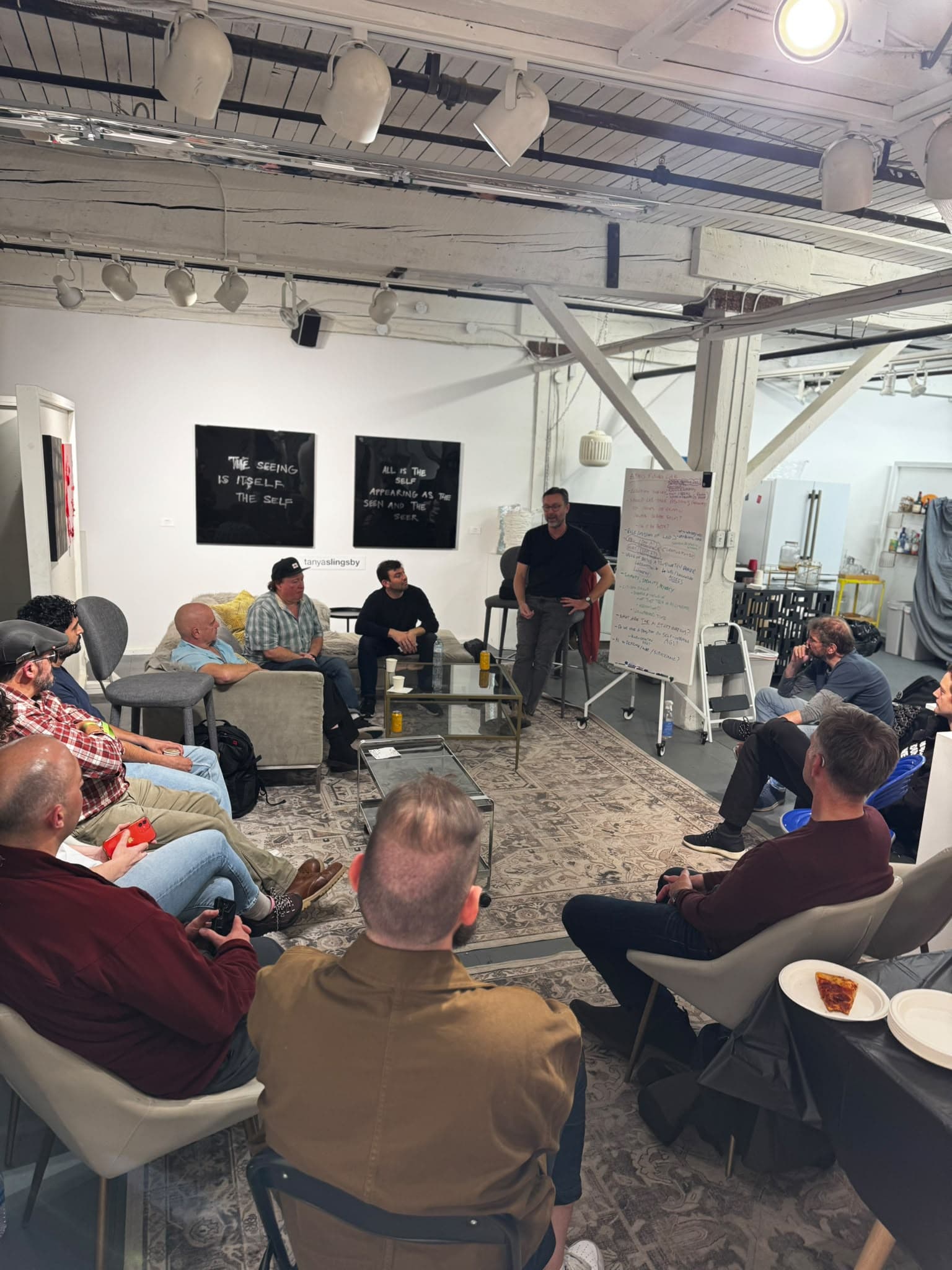 Participants seated in a circle around a whiteboard at Parker Street Studios.