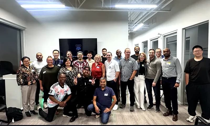 About twenty attendees of the first FV+AI meetup gather for a second, more relaxed group photo, several kneeling in the front row.