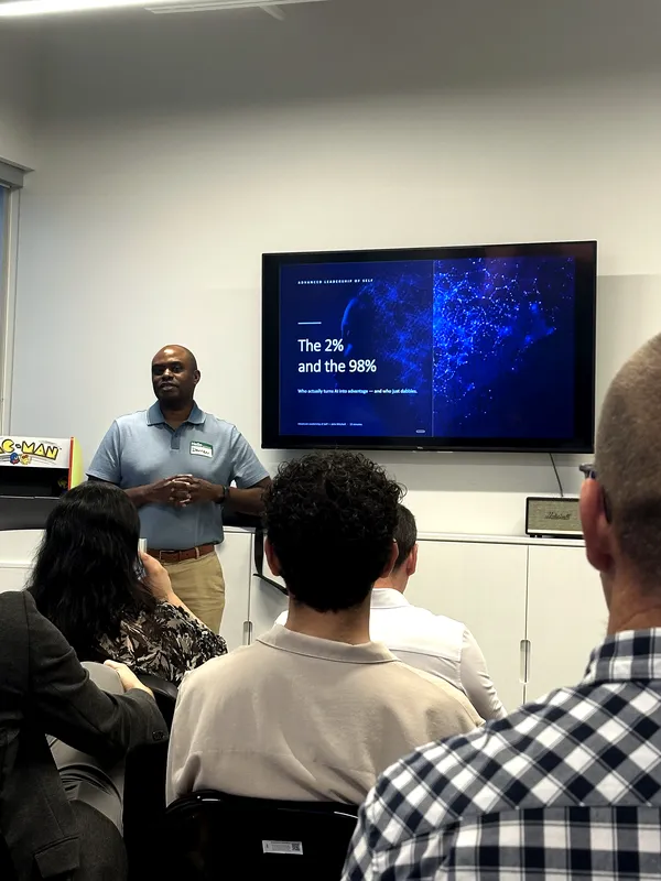 Darren presents a slide titled "The 2% and the 98%" to the room.