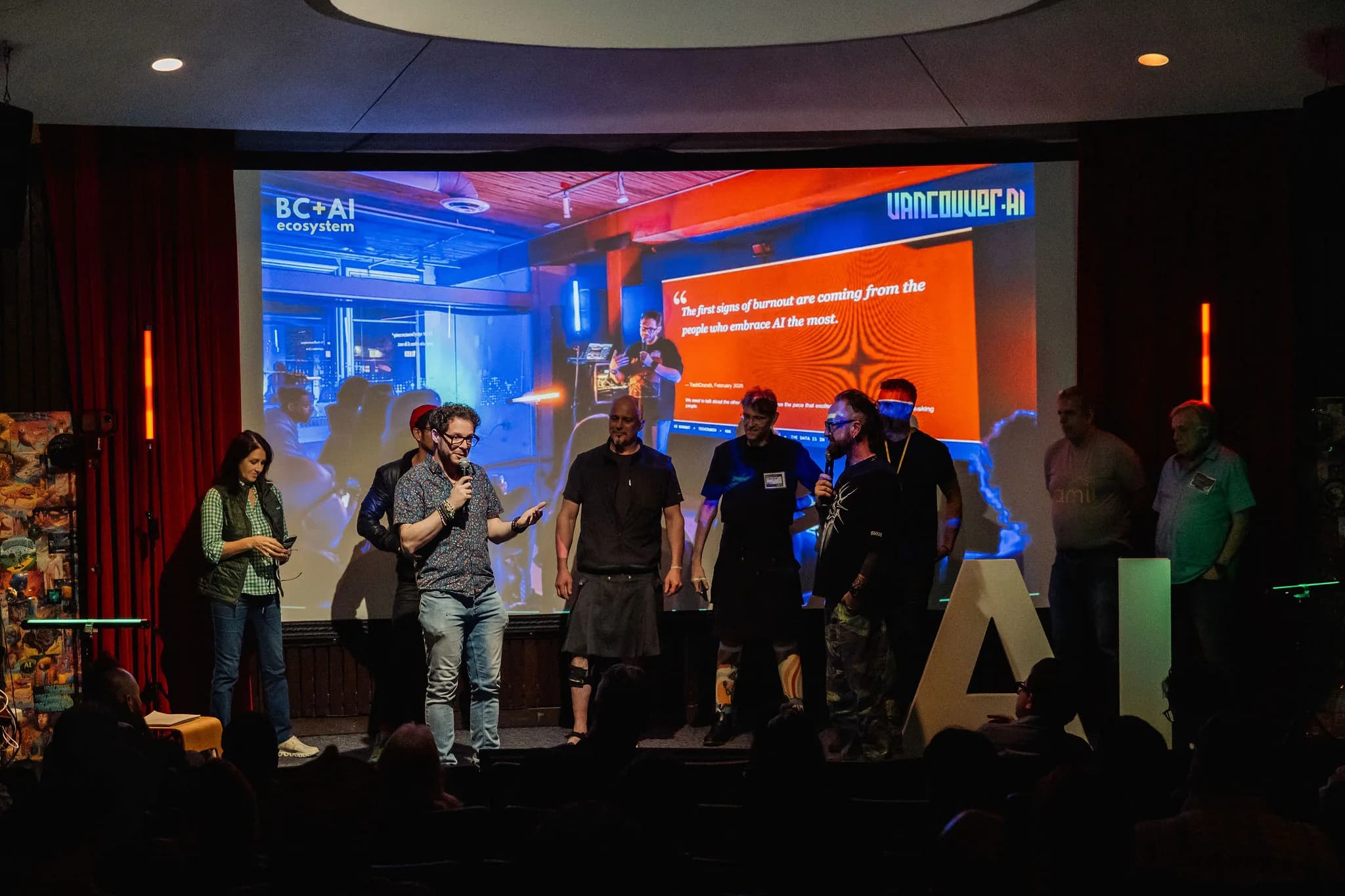 Film Club presenters sharing the April stage in front of a live projected workflow.