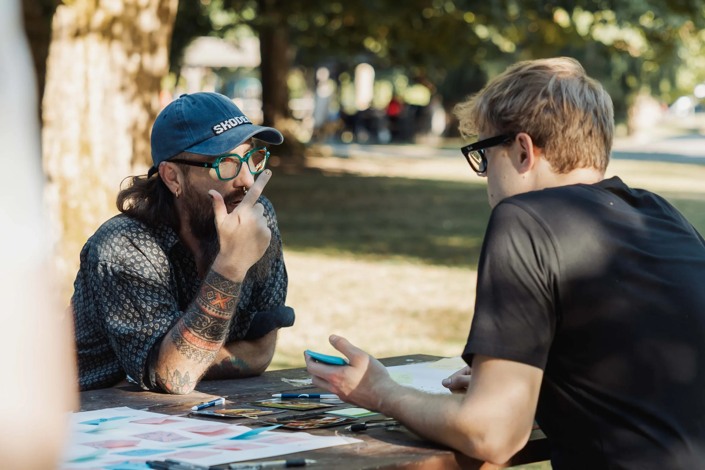 Surrey AI community members in conversation around a table at an outdoor meetup.
