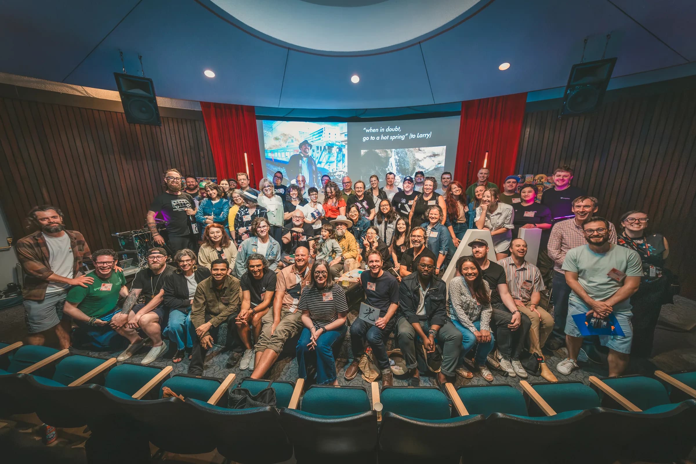 Vancouver AI Meetup #31 gathers on and in front of the stage for a group photo.