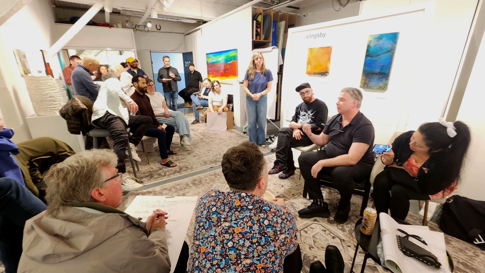 People seated in a discussion circle at an AI Ethical Futures Lab meetup.