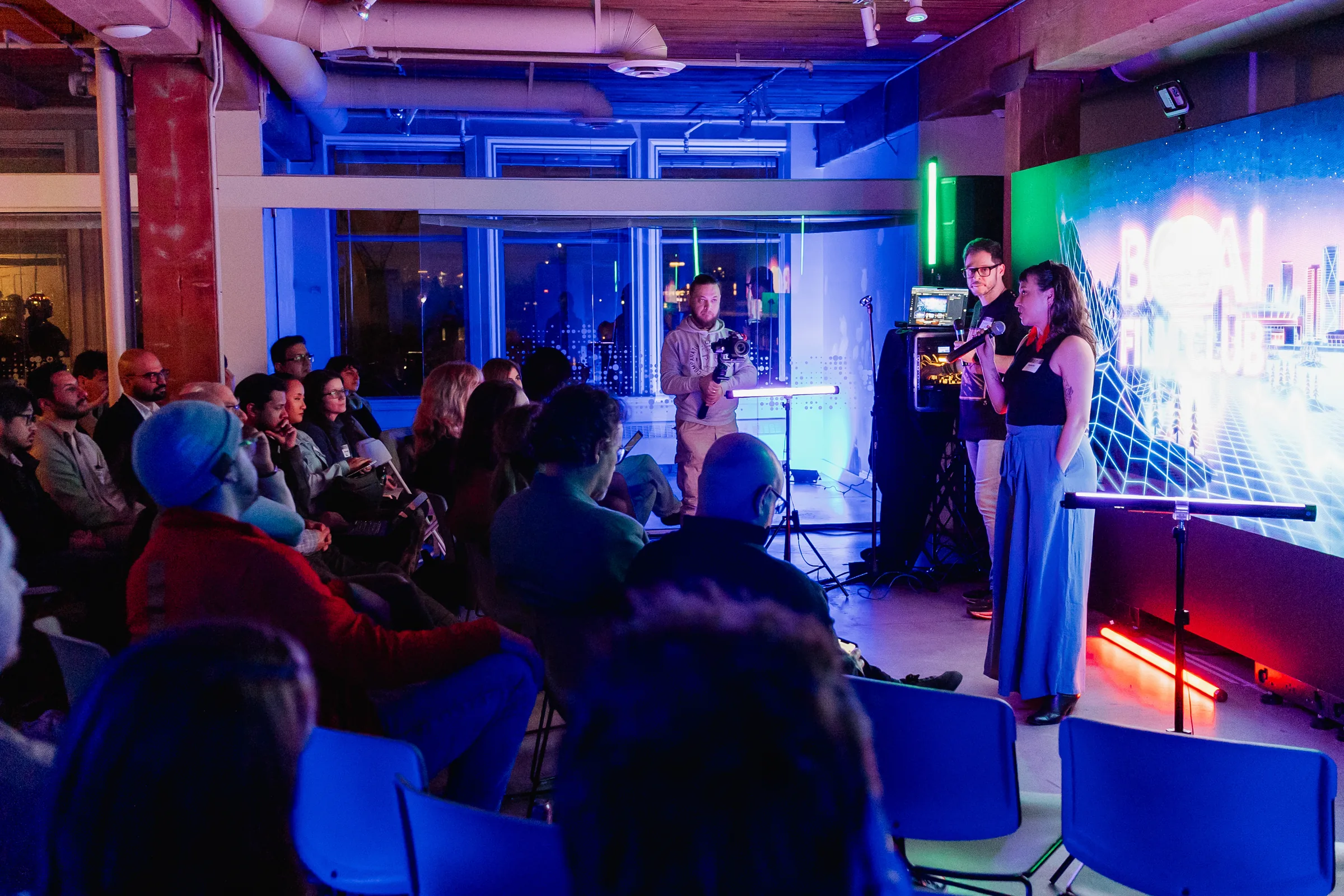 Recent AI Film Club night with seated audience, live demo station, and MML lighting.