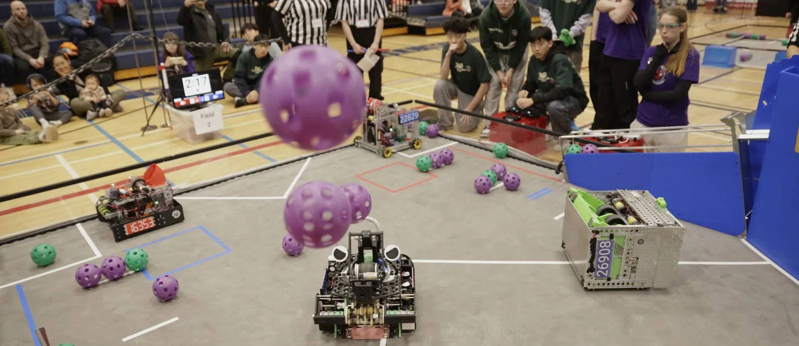 FIRST Tech Challenge robots launch purple game pieces during a 2026 match.