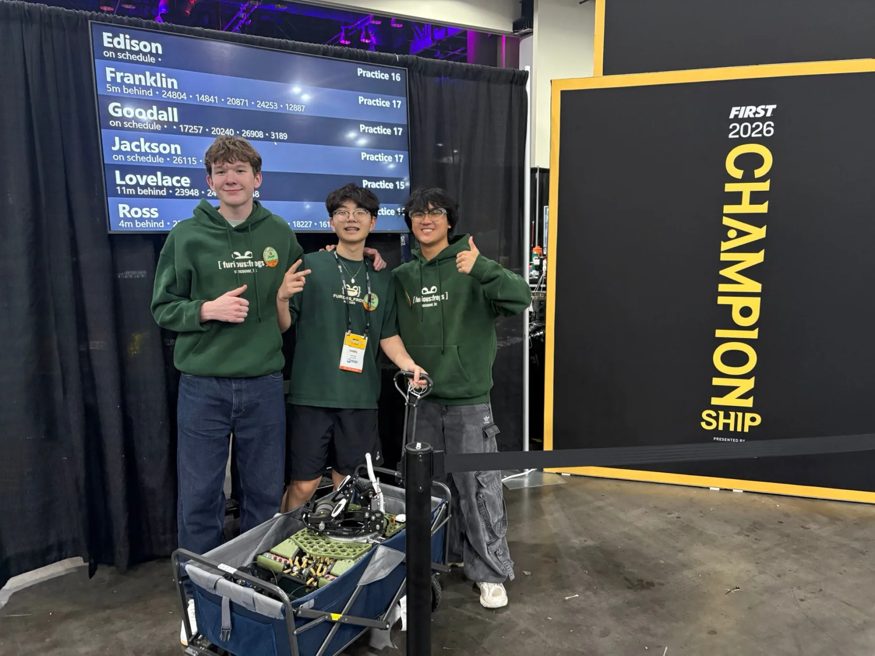Furious Frogs students stand with a robot in front of a FIRST Championship 2026 sign in Houston.