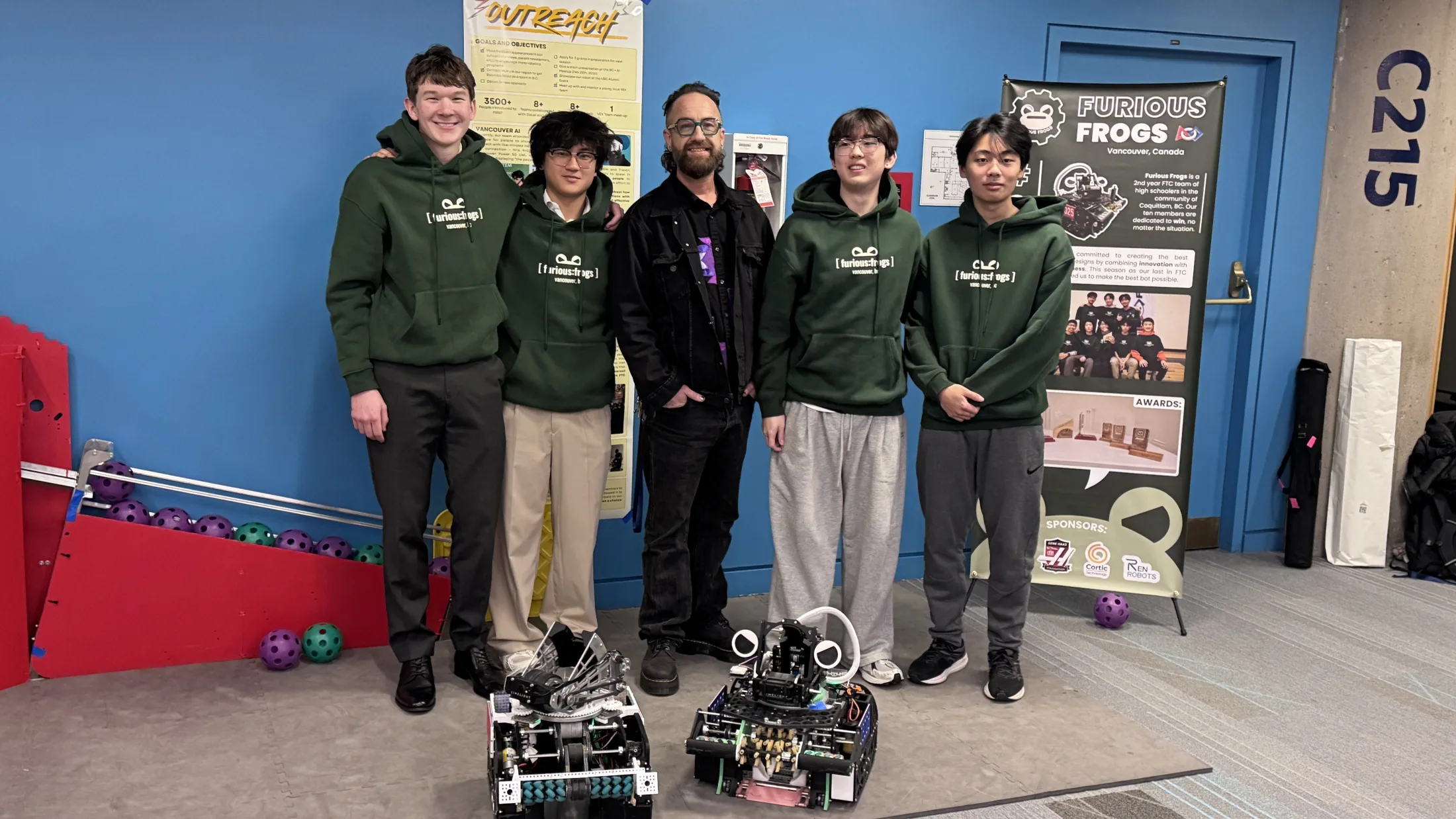 Kris Krug stands with Furious Frogs students and their robots at the FIRST Tech Challenge World Championship in Houston.